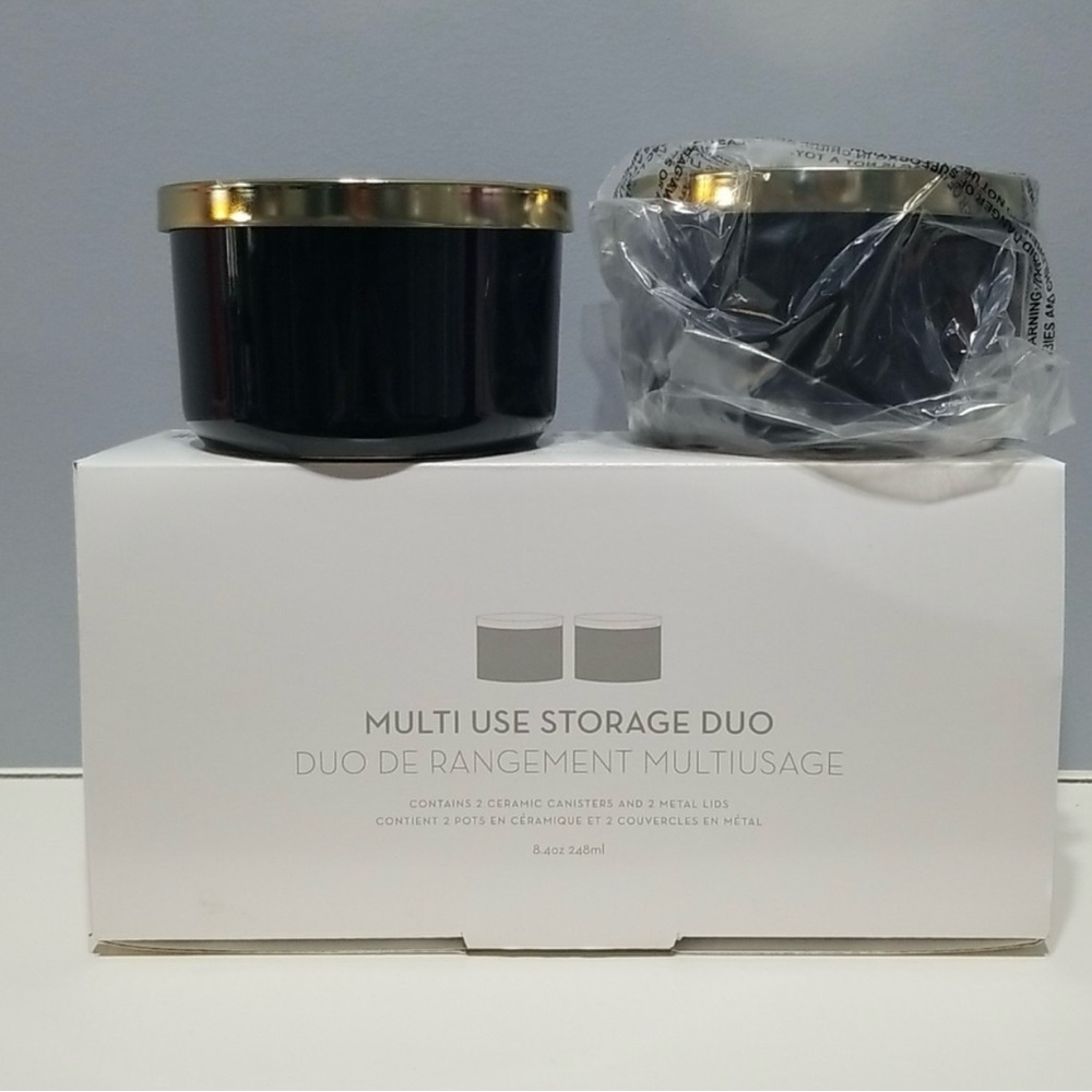NEW in box. Black Ceramic canisters with goldtone metal lids. 4” dia & 2.5” high